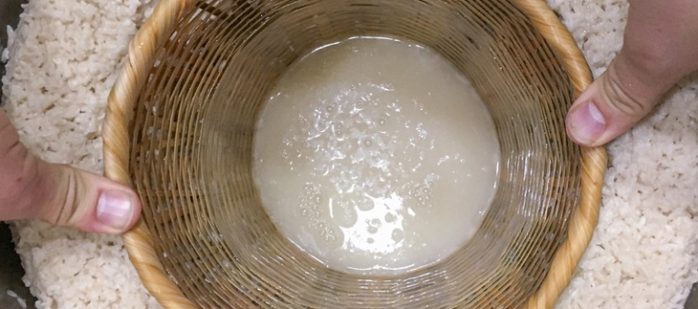 Soaked rice and starter in a traditional bamboo basket